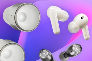 Different white and black earbuds floating around on a blue-pink background