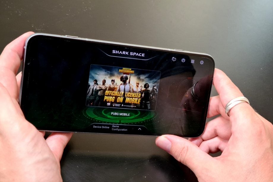 A silver Black Shark 3 Pro smartphone held in hand displaying PUBG Mobile on Shark space