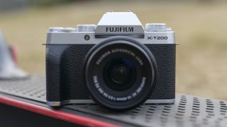 Front panel view of a silver-black Fujifilm XT200
