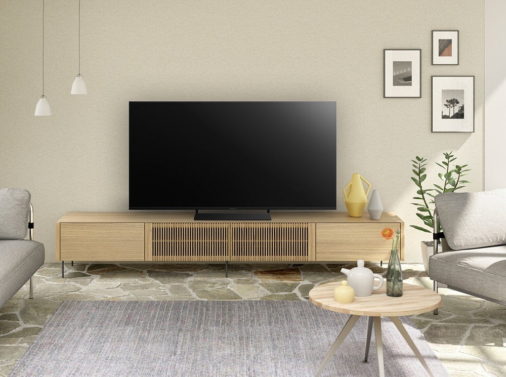 Panasonic HX800A black Panasonix HX800 TV standing on a wooden shelf in a living room