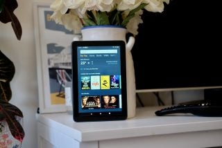 A black Fire HD 8 Plus standing against a plant pot facing back displaying for you section screen