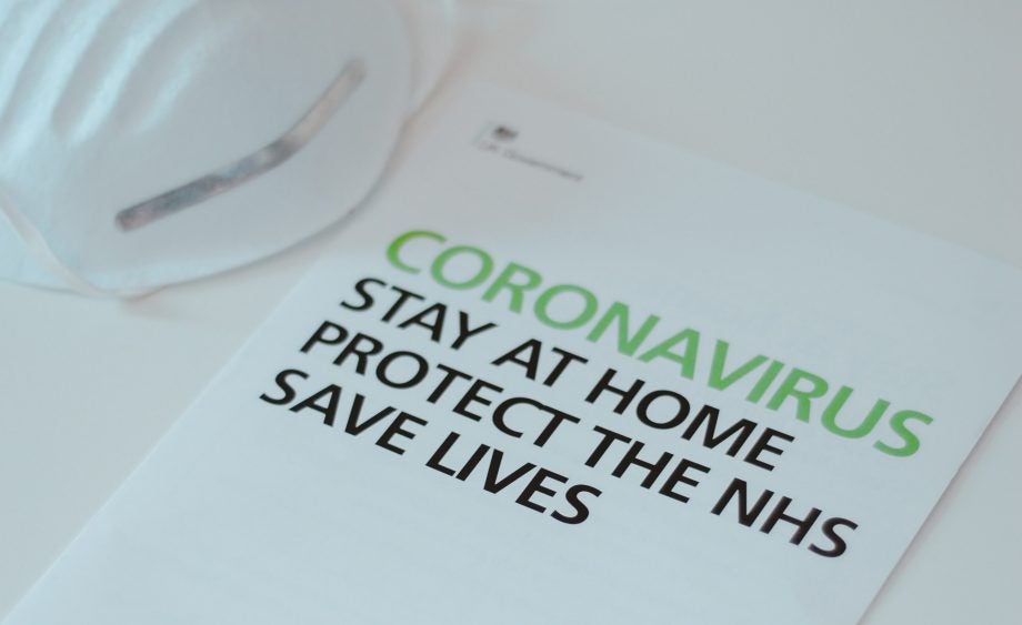 A pamphlet of Coronvirus, stay at home protect the NHS, save live, kept on a white table