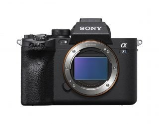 A black Sony A7S III standing on white background with lens removed