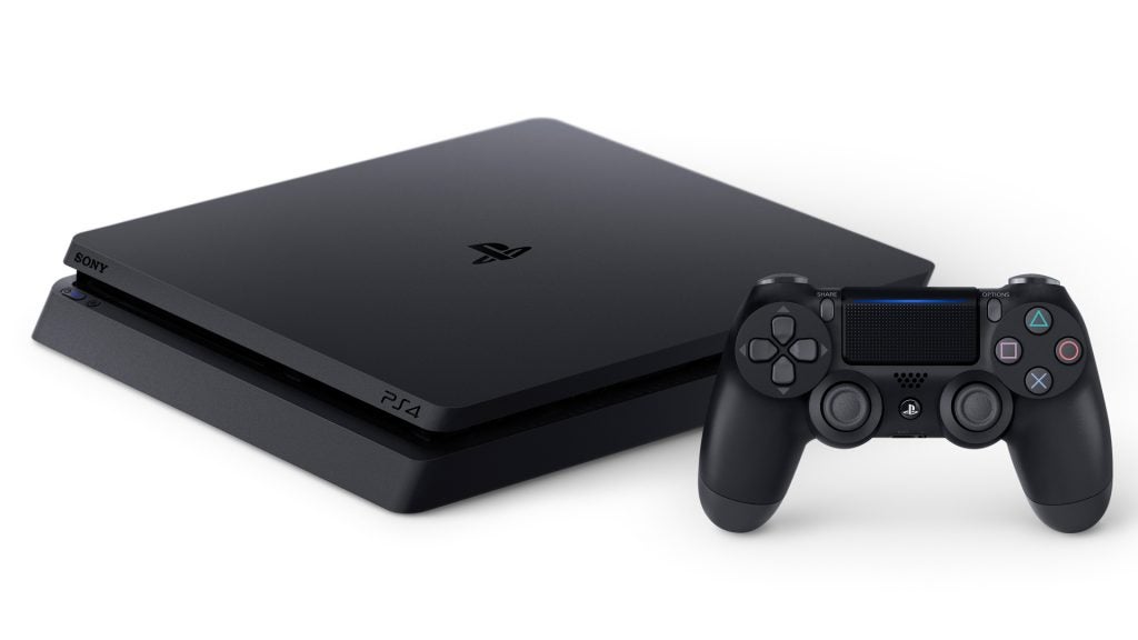 Black PS4 standing on white background with it's controller beside