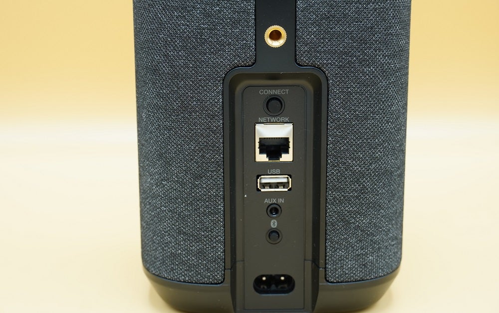 Close up image of a black Denon Home 150 speaker's ports section