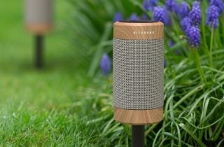 A silver-brown Diggit KSDIG55 speaker fixed on ground on stands