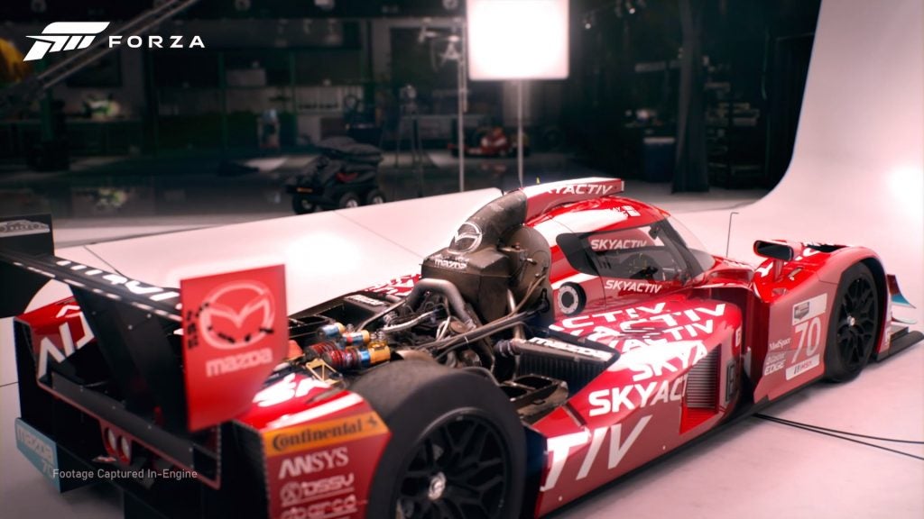 Picture of a red racing car with a Forza logo on top left corner