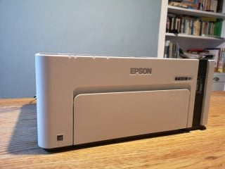 Front panel view of an Epson ET M1120 standing on a wooden table