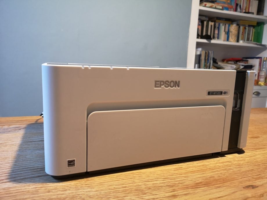 Front panel view of an Epson ET M1120 standing on a wooden table