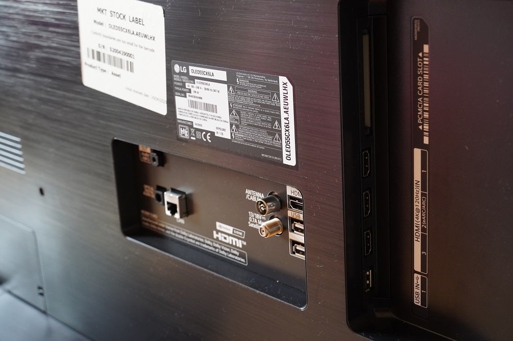 Close up image of ports section on back panel of a black LG CX TV