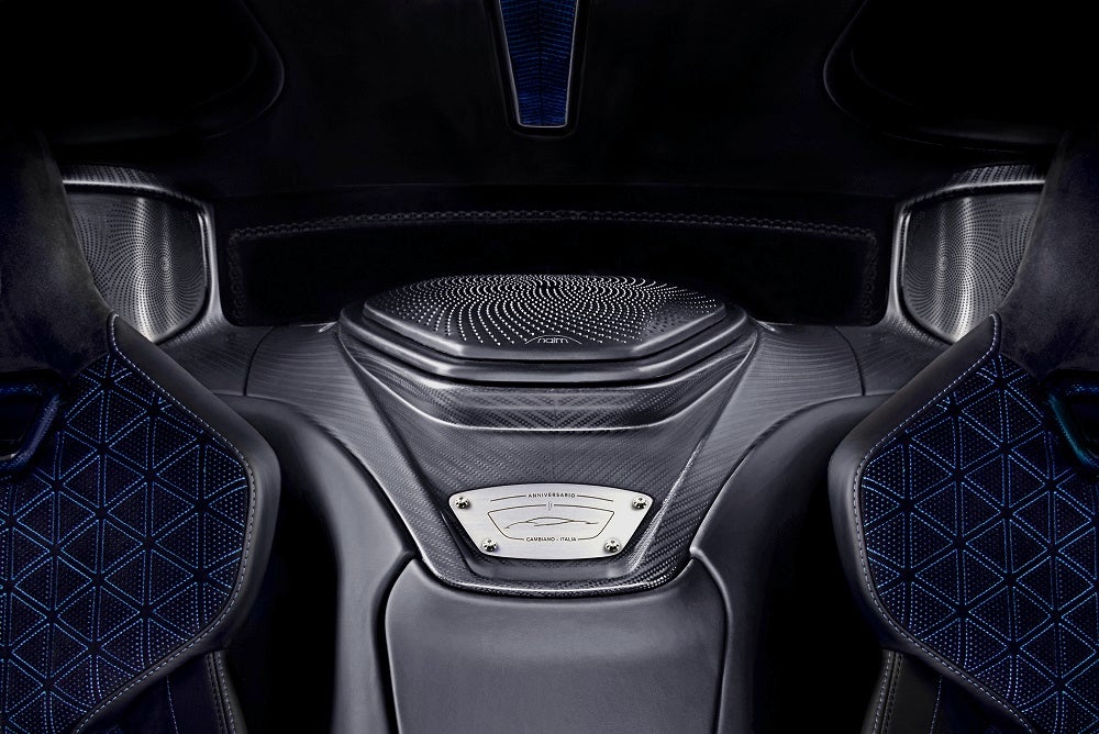 Picture of silver Naim speakers fitted behind the seats of Battista