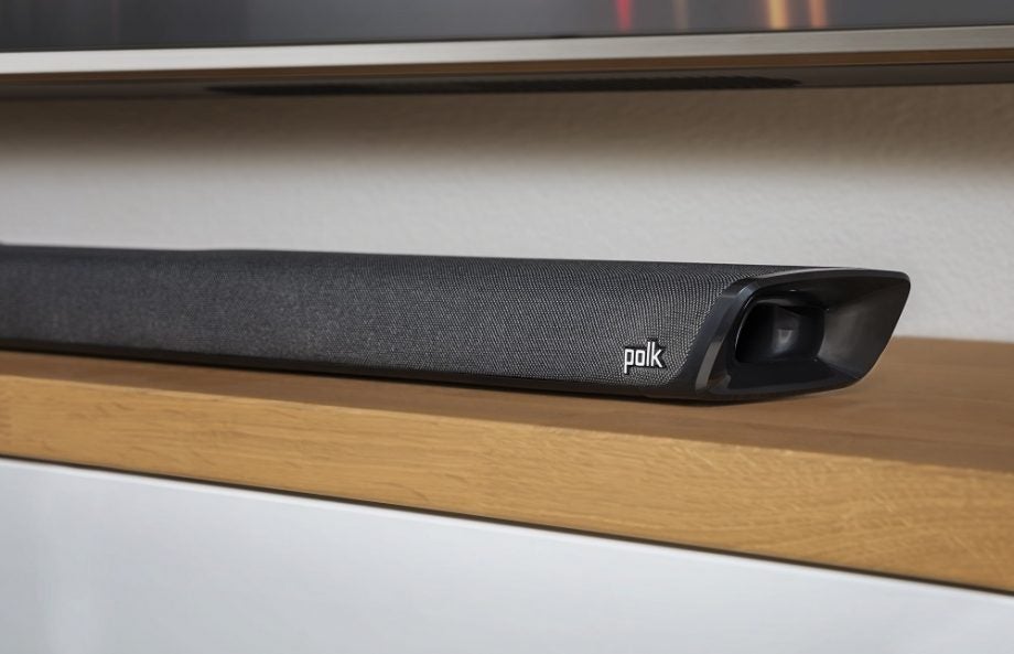 Polk Magnifi 2 black soundbar resting on a shelf below a TV