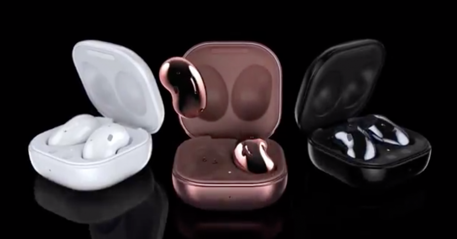Three different colored Samsung beans earbuds resting in their cases on a black background