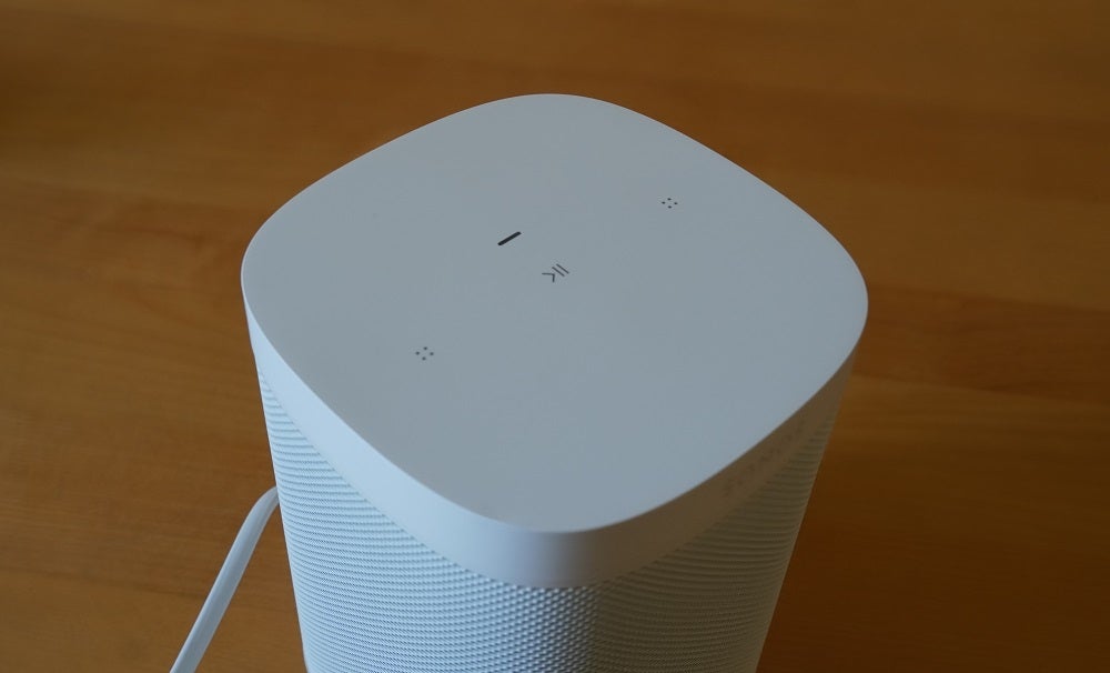 Top side view of a white Sonos One SL speaker standing on a table