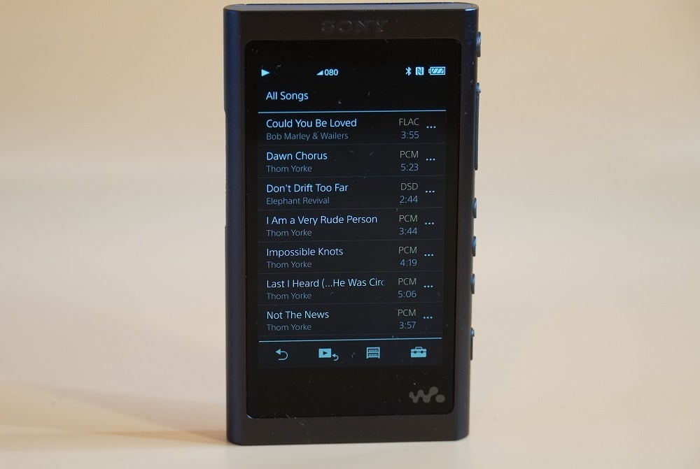 A black Sony NW A55 audio player standing and displaying all songs list