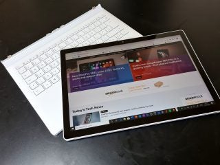 An undocked white Surface Book 3 resting on a table