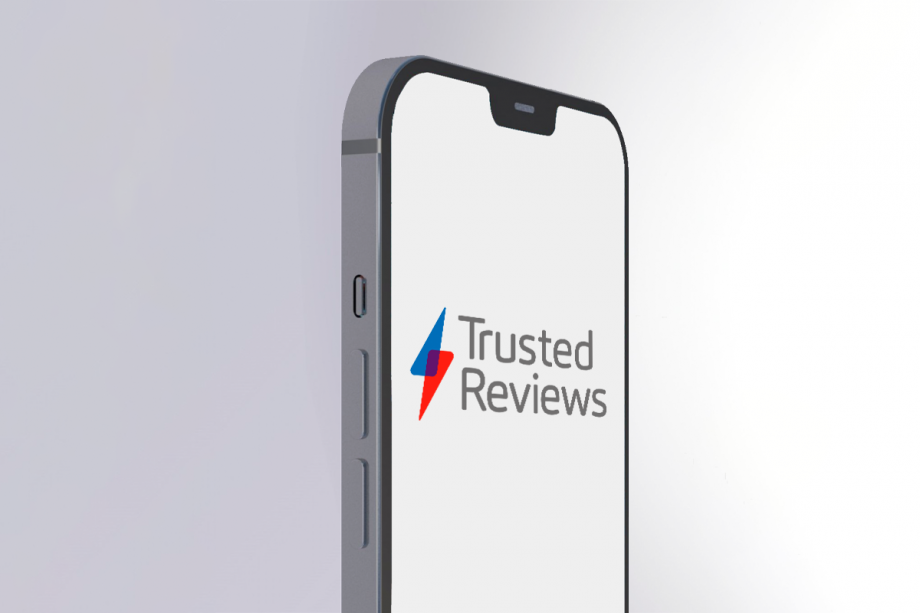 A gray iPhone 12 standing on a silver-white background displaying Trusted Reviews logo