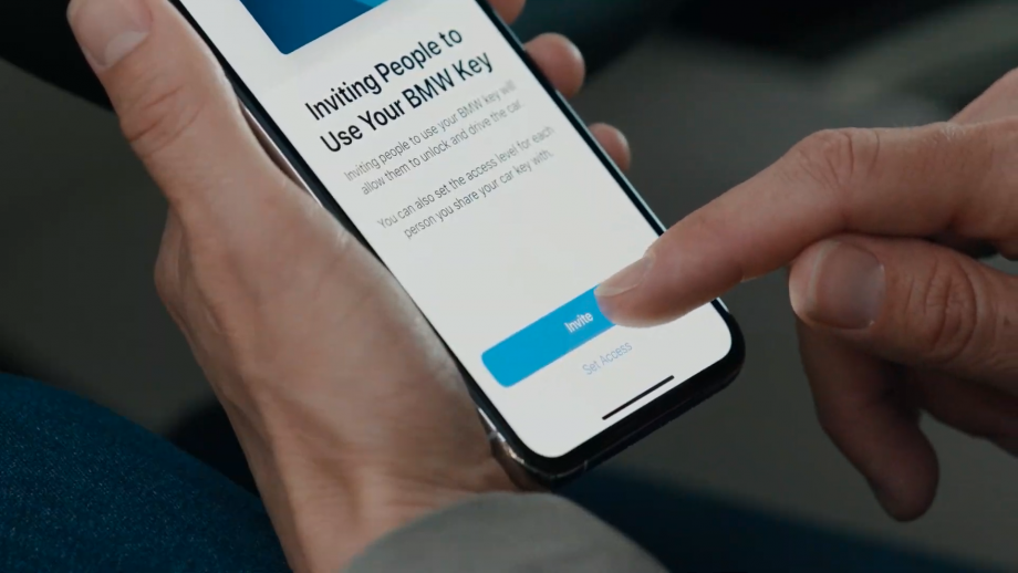 A smartphone held in hand displaying invite people to use your BMW key