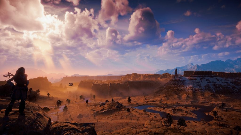 An animated wallpaper of a game, a girl standing on a hill on left and a barren land on the right