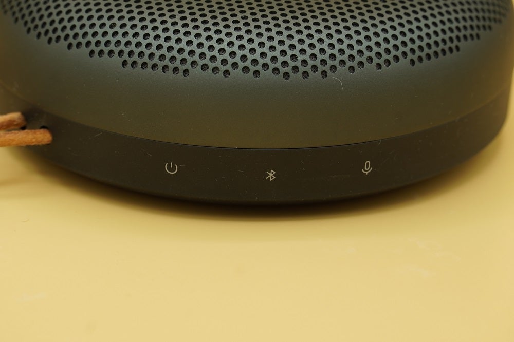 Close up image of a black BO Beosound A1 2nd Gen speaker's buttons