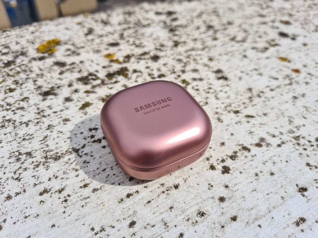 Samsung Galaxy Buds LiveBrown Galaxy Buds Live earbud's case resting on a concrete floor