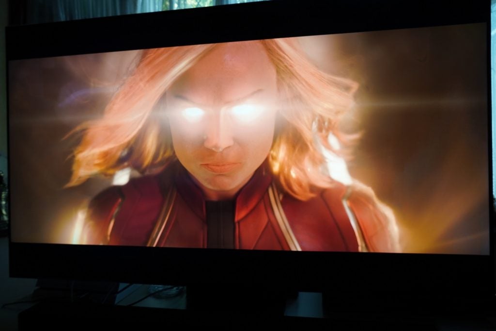 A black Samsung Q95T TV displaying a scene from Captain Marvel
