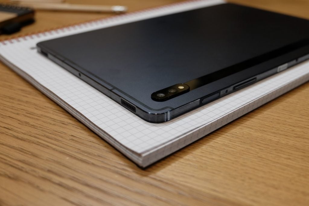 A black Samsung Galaxy Tab S7 plus kept upside down on a notebook