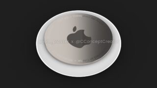 Close up image of an Apple AirTag placed on a black background