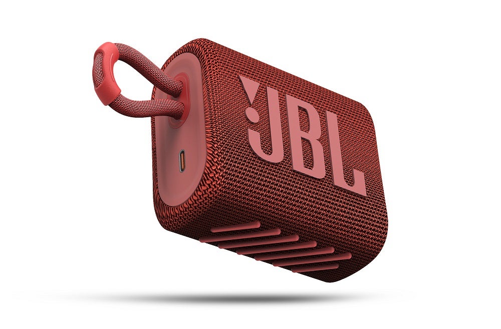A red JBL GO3 speaker floating on a white background