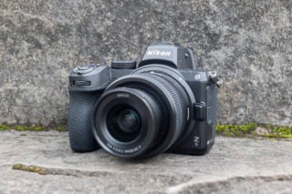 Front right view of a black  Nikon Z5 standing on a concrete floor