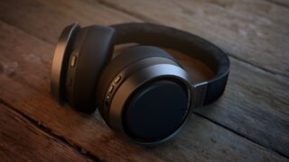 Right angled view of black Philips L3 Fidelio headphones resting on a wooden table