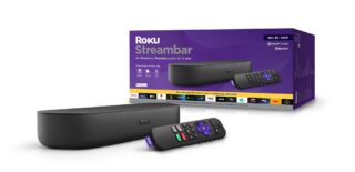 A black Roku streambar laid on a white background with it's remote laid beside and packaging box standing behind