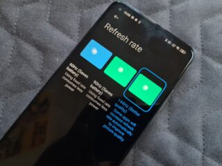 A black Xiaomi Mi 10T Pro smartphone laid on gray background, displaying Refresh rate options