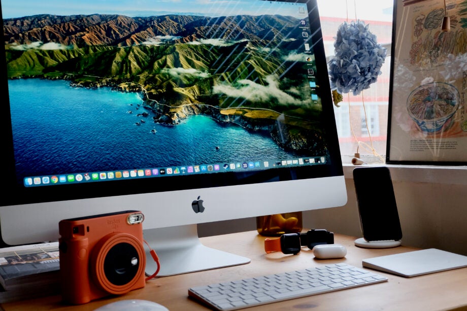 Left angled view of a completely set-up iMac on a table with accessories