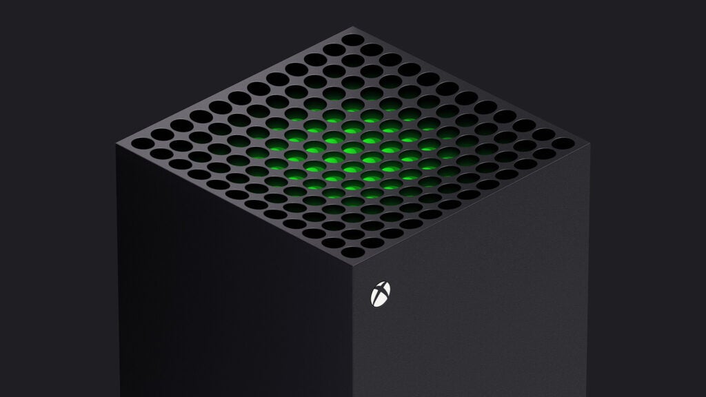 Front top side view of a gray Xbox standing on a black background