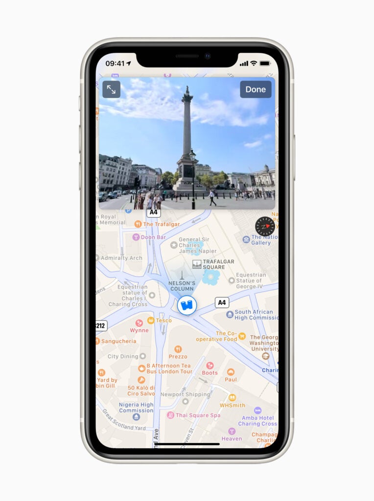 A black iPhone standing on a white background displaying a picture on Apple maps