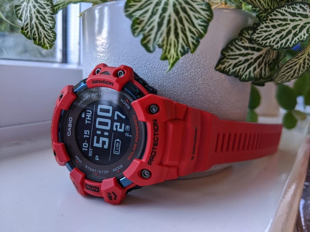 Casio G-Shock GBD-H1000A red Casio watch tied to white plat pot