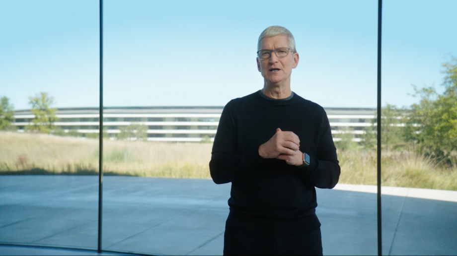 Tim Cook standing in black outift in front of a transparent glass wall