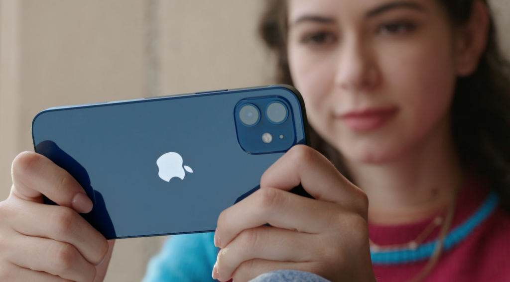 A blue iPhone held horizontally in a lady's hands