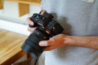 A black Sony A7s iii camera held in hand