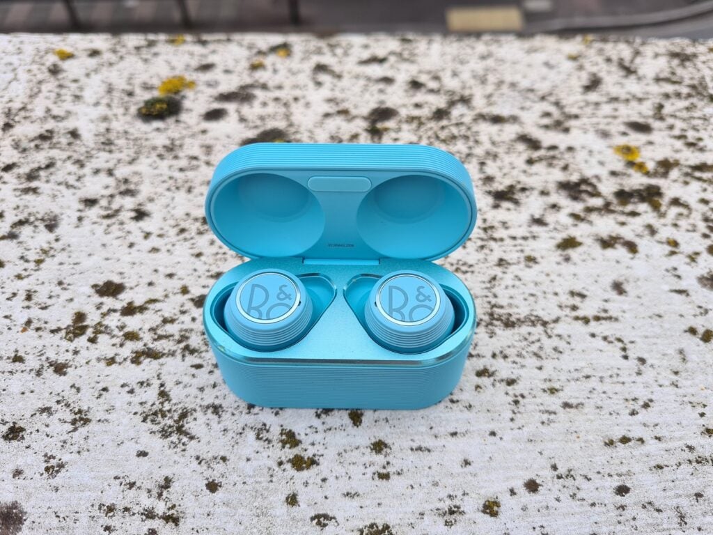 View from top of B&O blue earbuds resting in it's blue case 