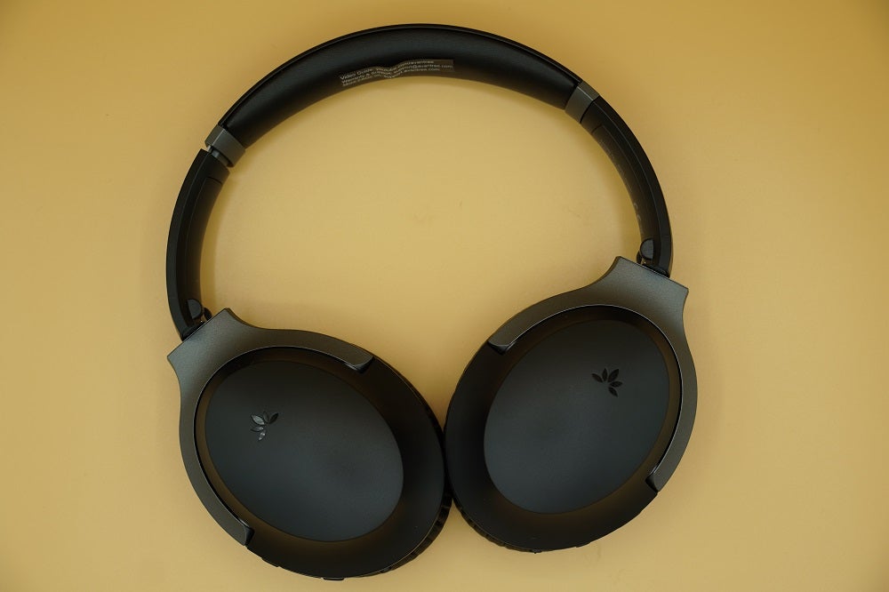 View from top, of black Avantree Aria Pro headphones resting on table