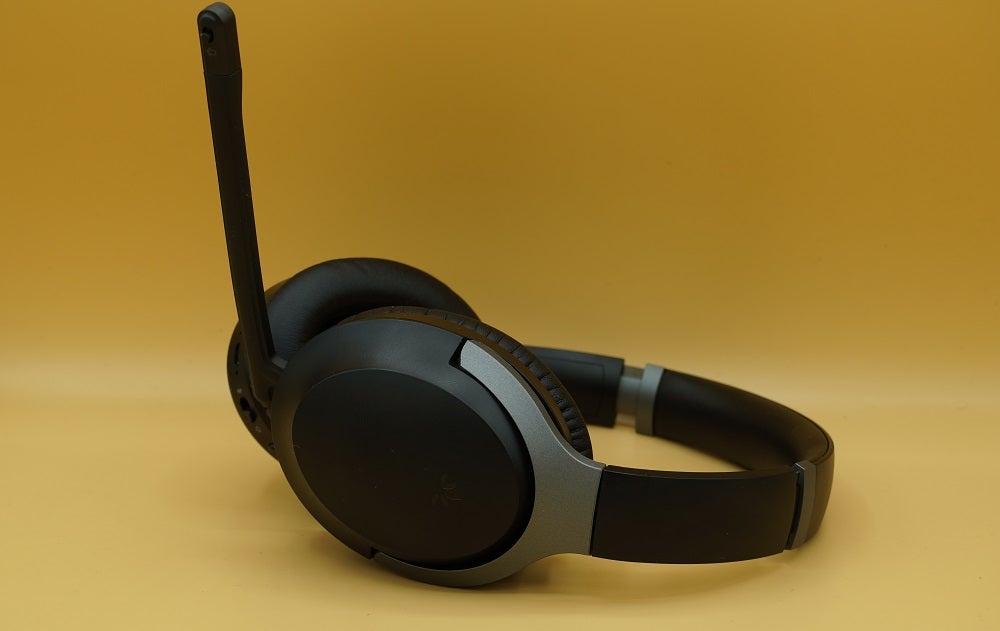 Black Avantree Aria Pro headphones resting on yellow background
