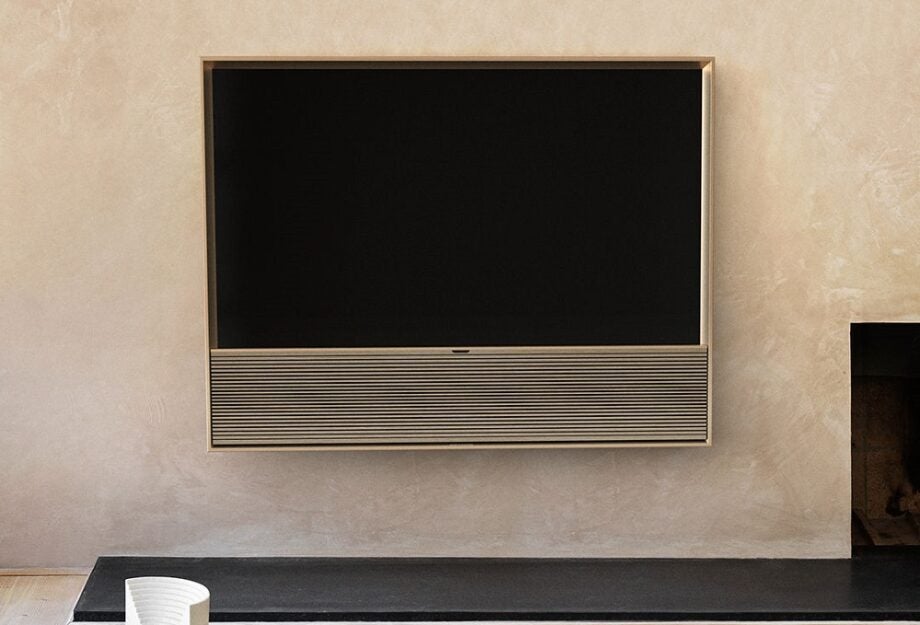 A golden-black BO Beovision Contour TV hanging to a wall