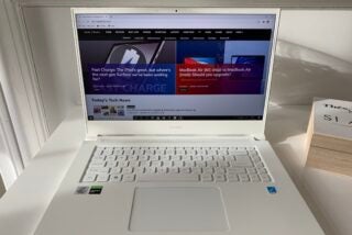 Front view of a white Acer ConceptD laptop kept on a white table