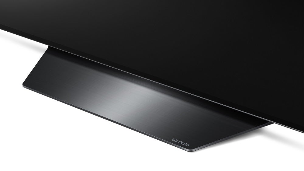 A silver-gray LG OLED BX TV's stand
