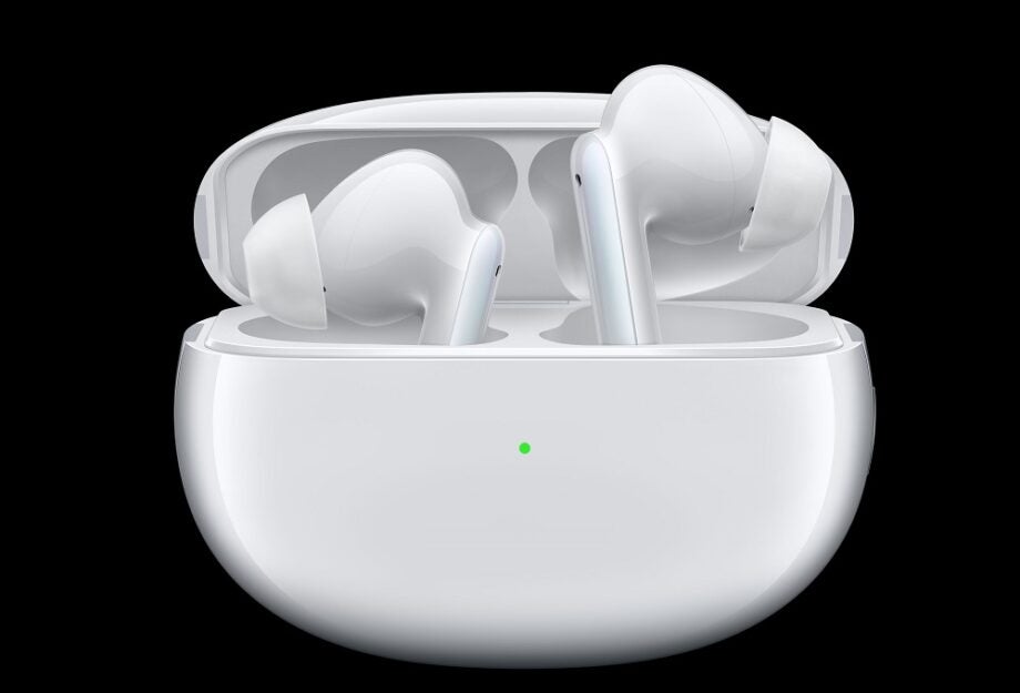 White Oppo Enco X TWS earbuds resting in it's white case on black background