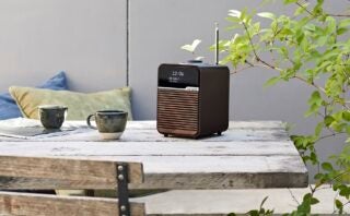 A brown-black R1MK4 radio standing on a wooden table