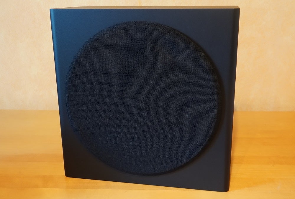Front view of black Samsung HW Q950T speaker's subwoofer standing on a table