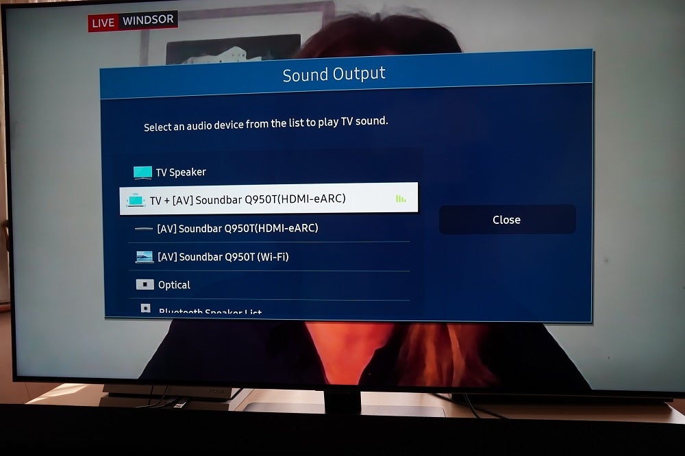 A black Samsung Q80T standing on a table displaying Sound output settings menu